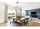 View of dining room with pendant lighting over wood table with a glimpse of the outdoor patio at 2948 Woods Edge Dr, Greenwood, IN 46143
