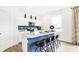 Bright kitchen featuring a blue kitchen island with white countertop, stainless steel appliances, and modern finishes at 2948 Woods Edge Dr, Greenwood, IN 46143