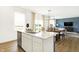 Open concept kitchen with quartz countertops that overlooks the dining and living room area with lots of natural light at 2948 Woods Edge Dr, Greenwood, IN 46143