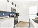 Modern kitchen with stainless steel appliances, quartz countertop, and dark blue accent wall at 2948 Woods Edge Dr, Greenwood, IN 46143