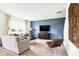 Cozy living room area featuring a large sofa with blue accent pillows and a leather accent chair at 2948 Woods Edge Dr, Greenwood, IN 46143