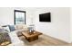 Bright living room features neutral tones, large sectional, and mounted tv at 2948 Woods Edge Dr, Greenwood, IN 46143