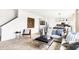 Open living room that flows into the kitchen and dining room area with large sofa and natural light at 2948 Woods Edge Dr, Greenwood, IN 46143