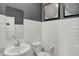 Charming bathroom with subway tile walls, stylish mirror, and a white sink and toilet at 3104 Glasgow Pl, Danville, IN 46122