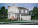 Charming two-story home showcasing a beautifully designed exterior with a two-car garage and a mix of textures and colors at 3104 Glasgow Pl, Danville, IN 46122