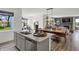 Open-concept kitchen with an island, stainless steel appliances, and an adjacent dining area with a wooden table at 3104 Glasgow Pl, Danville, IN 46122