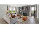Bright living room with fireplace, large windows, hardwood floors, and comfortable couches at 3104 Glasgow Pl, Danville, IN 46122
