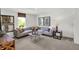 Bright living room with a gray sectional, a modern table, and light gray walls at 3104 Glasgow Pl, Danville, IN 46122