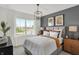 Serene main bedroom showcasing a large window, modern lighting, and sophisticated decor at 3104 Glasgow Pl, Danville, IN 46122
