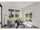 Cozy sitting room with a view to the yard, white walls, comfortable seating, and a glass table at 3104 Glasgow Pl, Danville, IN 46122