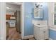 Bathroom sink and mirror; the kitchen is visible through the doorway at 3134 N College Ave, Indianapolis, IN 46205