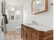 A bathroom features a vintage vanity, sink, mirror, and a shower/tub at 3134 N College Ave, Indianapolis, IN 46205