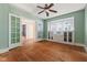 Comfortable bedroom featuring a ceiling fan, hardwood floors, and natural light at 3134 N College Ave, Indianapolis, IN 46205