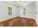A bedroom features hardwood floors and two windows for natural light at 3134 N College Ave, Indianapolis, IN 46205