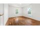 A bedroom features hardwood floors and two windows for natural light at 3134 N College Ave, Indianapolis, IN 46205
