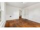 A bedroom features hardwood floors and a door to another room at 3134 N College Ave, Indianapolis, IN 46205