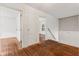 Hallway with hardwood floors leads to the various rooms of the house at 3134 N College Ave, Indianapolis, IN 46205