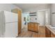 Bright kitchen with white refrigerator and rolling kitchen island at 3134 N College Ave, Indianapolis, IN 46205