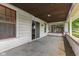 A covered porch with a neutral color scheme, and access to the home's interior at 3134 N College Ave, Indianapolis, IN 46205