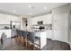 Bright kitchen with an island, modern appliances, white cabinets, and bar stool seating at 3200 Glasgow Pl, Danville, IN 46122