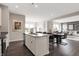 Modern kitchen with sleek countertops, island with seating, stainless steel appliances, and open to dining and living areas at 3200 Glasgow Pl, Danville, IN 46122