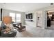 Inviting living room with gray sofa, modern TV setup, and natural light from large windows at 3200 Glasgow Pl, Danville, IN 46122
