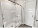 Modern shower with glass door adjacent to a white panel door for easy access at 3200 Glasgow Pl, Danville, IN 46122