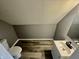 This bathroom has a toilet, sink, gray paint, and neutral flooring at 3305 N Arlington Ave, Indianapolis, IN 46218