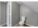 This bathroom has a toilet, gray paint, and neutral flooring at 3305 N Arlington Ave, Indianapolis, IN 46218