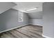 A bedroom featuring wood-look floors, neutral paint, and natural light at 3305 N Arlington Ave, Indianapolis, IN 46218