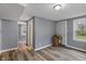 Bedroom with grey walls, white trim, and modern wood-look flooring at 3305 N Arlington Ave, Indianapolis, IN 46218