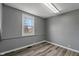 This bedroom features wood-look floors, a window, and neutral paint at 3305 N Arlington Ave, Indianapolis, IN 46218