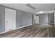 Spacious living room with grey walls, white trim, and wood-look flooring at 3305 N Arlington Ave, Indianapolis, IN 46218