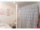Simple bathroom featuring patterned shower curtain, vanity with sink, and decorative wall art at 3514 Summerfield Dr, Indianapolis, IN 46214