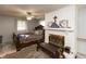 Comfortable bedroom featuring a large bed, wood fireplace, and ceiling fan at 3514 Summerfield Dr, Indianapolis, IN 46214