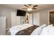 Relaxing bedroom featuring a mounted television, ceiling fan, and a double closet at 3514 Summerfield Dr, Indianapolis, IN 46214