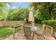 Cozy deck area furnished with a glass-topped table and comfortable chairs for outdoor relaxation at 3514 Summerfield Dr, Indianapolis, IN 46214