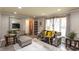 Cozy living room provides natural light, modern decor, and a large mirror creating an open, airy atmosphere at 3514 Summerfield Dr, Indianapolis, IN 46214