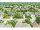 Aerial view of the home in a neighborhood featuring mature trees, well-manicured lawns, and quiet residential streets at 3655 Copperleaf Blvd, Greenwood, IN 46143