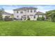 This expansive backyard features a patio with a seating area, a hot tub, a lush lawn, and a light brick home at 3655 Copperleaf Blvd, Greenwood, IN 46143