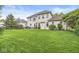 Expansive backyard featuring a well-manicured lawn, a light brick home, and a patio with outdoor furniture at 3655 Copperleaf Blvd, Greenwood, IN 46143
