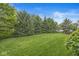 Lush backyard featuring a well-maintained lawn and mature trees surrounding the property, offering ample privacy at 3655 Copperleaf Blvd, Greenwood, IN 46143