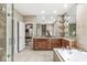 Bathroom featuring double sinks, custom cabinetry, large mirror, walk-in shower, and jetted tub at 3655 Copperleaf Blvd, Greenwood, IN 46143