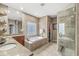 Elegant bathroom features a soaking tub with tile surround and a glass-enclosed shower at 3655 Copperleaf Blvd, Greenwood, IN 46143