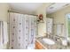 Cozy bathroom featuring a granite countertop vanity with a patterned shower curtain at 3655 Copperleaf Blvd, Greenwood, IN 46143