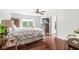 Bright bedroom featuring hardwood floors, ceiling fan, and walk-in closet access at 3655 Copperleaf Blvd, Greenwood, IN 46143
