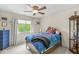bedroom with a plush bed, ceiling fan, and bright window at 3655 Copperleaf Blvd, Greenwood, IN 46143