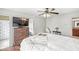 Bright bedroom with walk-in closet and bathroom access with overhead ceiling fan at 3655 Copperleaf Blvd, Greenwood, IN 46143