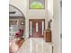 Grand foyer featuring a high ceiling, elegant chandelier, tile flooring, and a view of the front door at 3655 Copperleaf Blvd, Greenwood, IN 46143