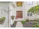 Elegant front entrance featuring a beautiful wooden door, decorative hanging planters, and inviting details at 3655 Copperleaf Blvd, Greenwood, IN 46143